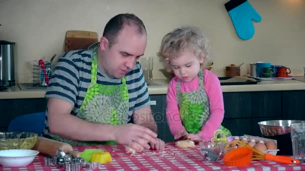 father and pretty daughter enjoy kneading dough together and making cookies - Footage, Video