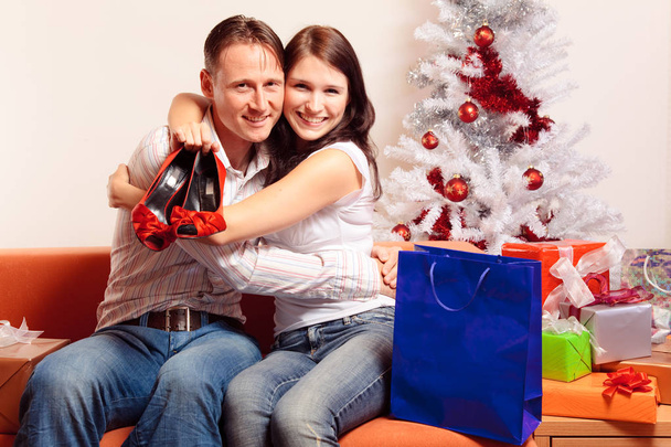Young Couple Exchanging Christmas Gifts - Fotografie, Obrázek