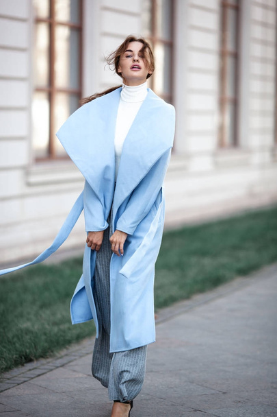 young beautiful stylish woman walking in street in blue coat, au - Fotografie, Obrázek