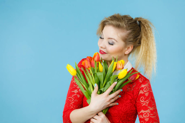 Pretty woman with red yellow tulips bunch - Photo, image