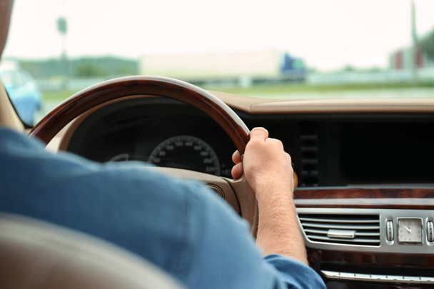 Mladý muž drží ruku na volant automobilu - Fotografie, Obrázek