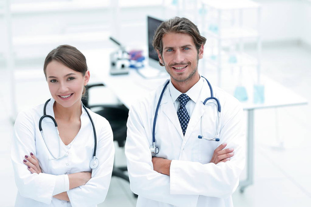 Portrait of two successful professional doctors workers in coats - Foto, Bild