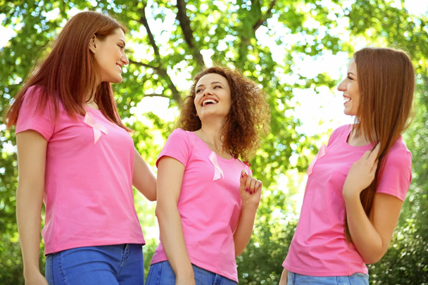 Young women in pink t-shirts outdoors. Breast cancer awareness concept - Фото, изображение