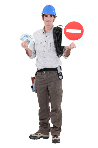 Road worker holding a traffic sign and bills - 写真・画像