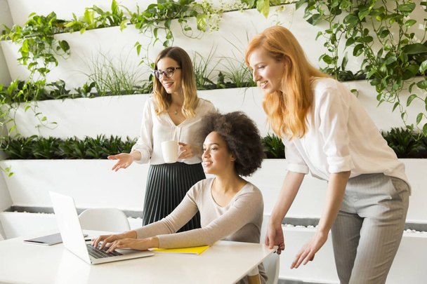 drie jonge vrouwelijke ondernemers in het kantoor - Foto, afbeelding