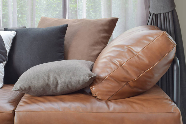 t καφέ δερμάτινο καναπέ κρεβάτι ποικίλλει χρώμα και μέγεθος μαξιλάρια - Φωτογραφία, εικόνα