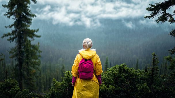 Дівчина в жовтому дощі на горі
 - Фото, зображення