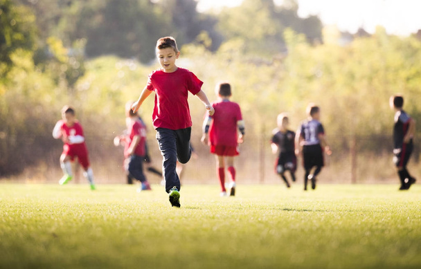 Kids soccer football - children players match on soccer field  - Foto, afbeelding