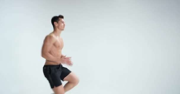 Muscular man warming up against white background. RED EPIC - Filmati, video