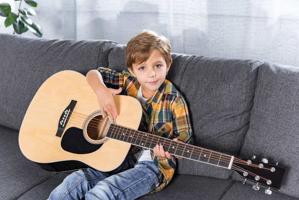 little boy with acoustic guitar - Foto, afbeelding