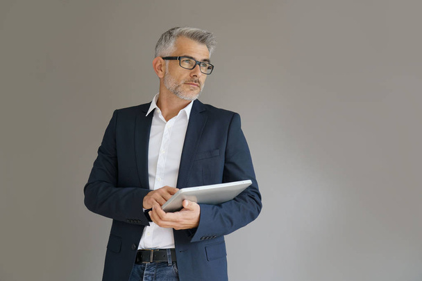 Trendy businessman using tablet - Fotó, kép