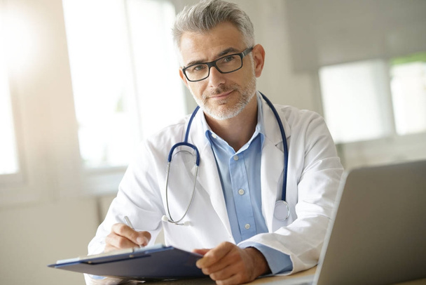 doctor working on patient file - Photo, Image