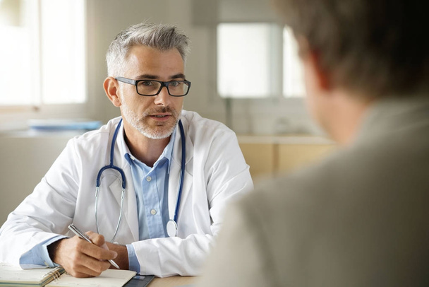 Doctor talking to patient - Фото, изображение