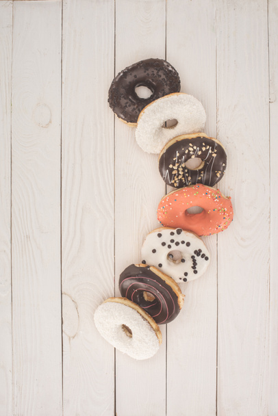 donuts on wooden table top - Fotografie, Obrázek