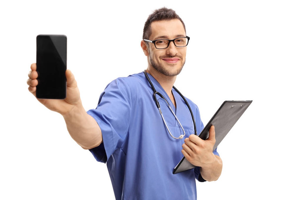 Doctor with a clipboard showing a phone - Foto, Imagen