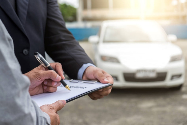 Insurance Agent examine Damaged Car and customer filing signatur - Photo, image