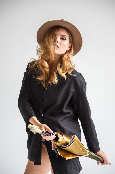 model in black shirt and hat with umbrella  - 写真・画像