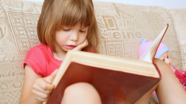 Little girl reading a big book - Footage, Video
