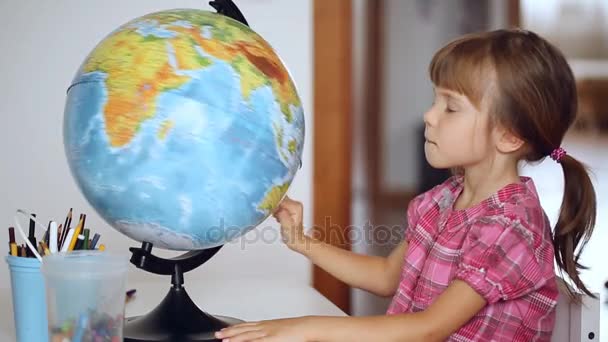 Little girl choosing location of the next vacation - Footage, Video