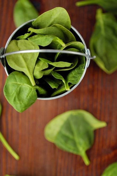 Delicious fresh spinach in a little bucket on the table  - Photo, Image