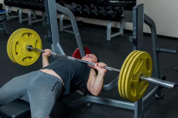The man gym doing exercises. Sports concept.  - Фото, изображение