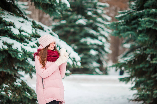 Beautiful woman outdoors on beautiful winter snow day in forest - 写真・画像