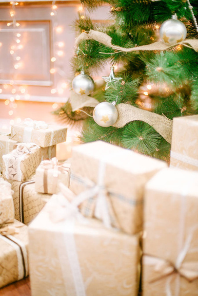 Presents under Christmas Tree in living room. Family Holiday New Year - 写真・画像