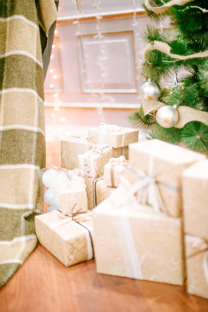 Presents under Christmas Tree in living room. Family Holiday New Year - Photo, image