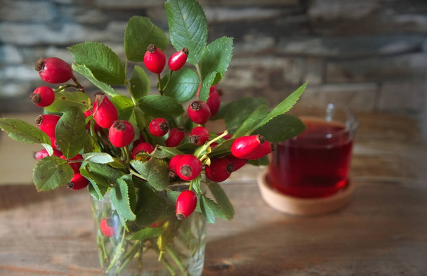 Bouquet of rose hips on the wooden background.Dried Fruits.Autumn seasonal concept. - Photo, Image