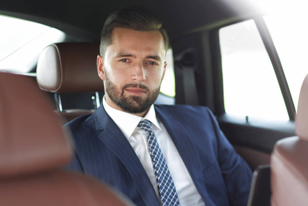 Close-up of a successful businessman sitting in a car - Фото, изображение