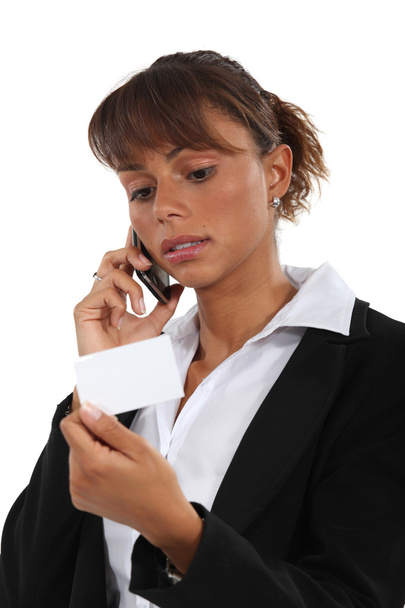 Woman with telephone and business card - Φωτογραφία, εικόνα