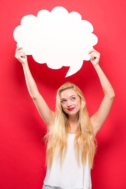 Young woman holding a speech bubble  - Foto, afbeelding