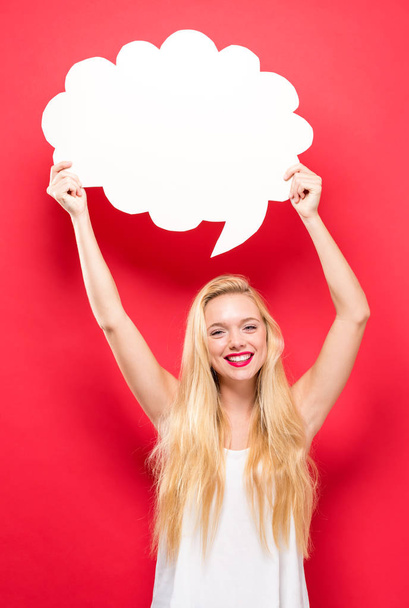 Young woman holding a speech bubble  - Photo, image
