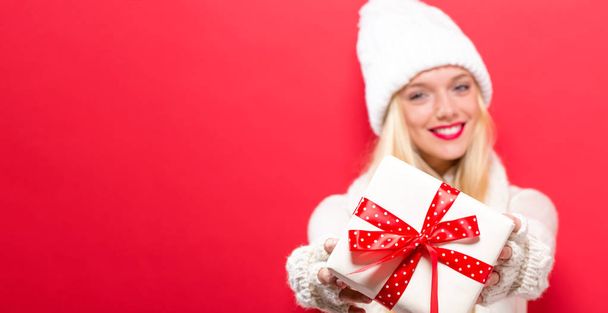 Young woman holding a Christmas gift - Foto, imagen