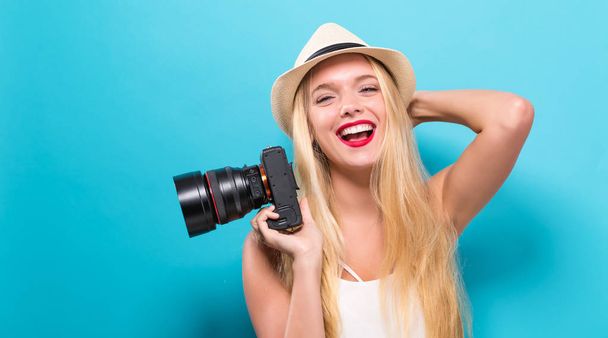Young woman comparing professional camera - Fotó, kép
