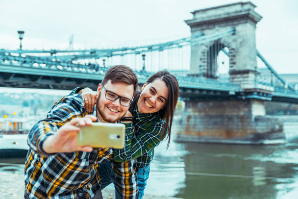 lovely cople taking selfie bridge on background - Photo, Image