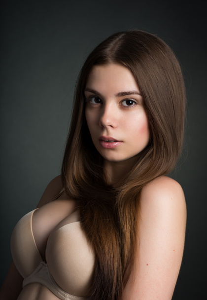 s A girl with a big neckline posing in the studio - Photo, Image