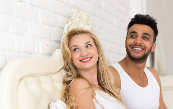 Young Couple Lying In Bed, Happy Smile Hispanic Man And Woman Looking Up To Copy Space - Foto, Imagen