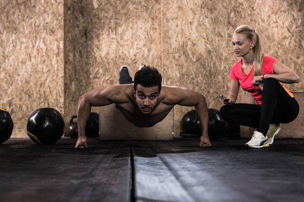 Sport Fitness People Crossfit Training, Young Healthy Hispanic Man Do Push Ups Woman Trainer - Photo, Image