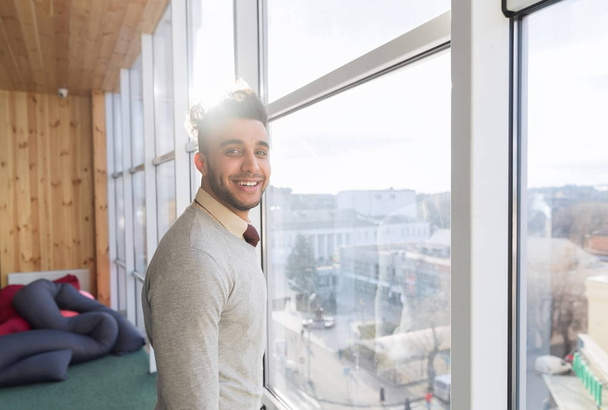 Hispanic Business Man Stand In Front Panoramic Window Happy Smiling Businessman - 写真・画像