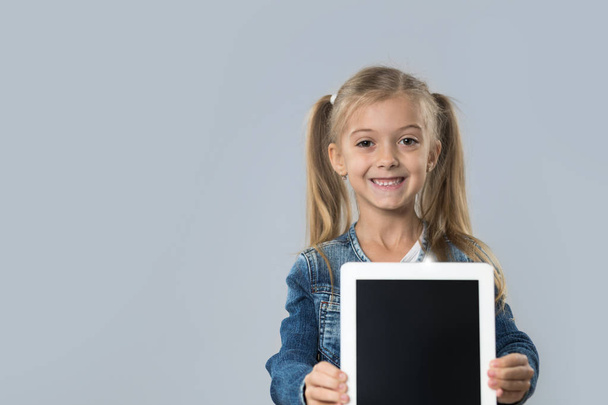 Beautiful Little Girl Hold Tablet Computer Empty Screen Happy Smiling Wear Jeans Coat Isolated - Fotografie, Obrázek