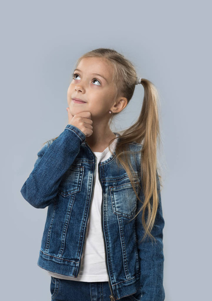 Beautiful Little Girl Happy Smiling Wear Jeans Coat Isolated Looking Up To Copy Space - Fotografie, Obrázek