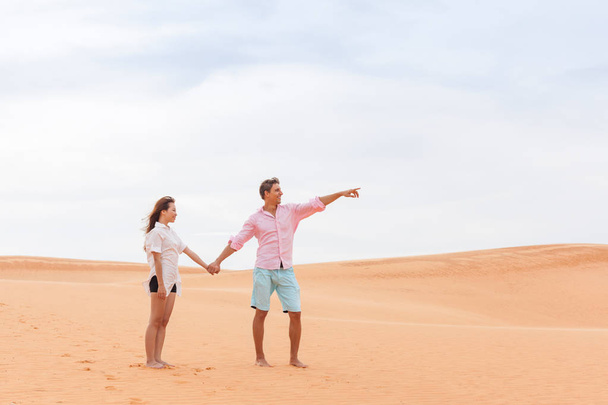 Young Man Woman In Desert Beautiful Couple Asian Girl And Guy Point Finger Sand Dune - Zdjęcie, obraz