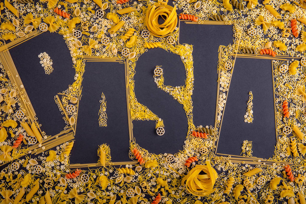 Word Pasta made from different types of pasta products on a blac - 写真・画像