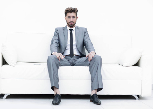 Successful businessman sitting in a suit smokes - Photo, Image