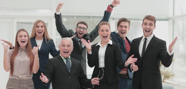 Victory in business. Happy businessman and  team on offi - Fotografie, Obrázek