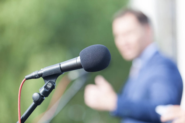 Speaker. Speech. Microphone. News conference. - Photo, Image