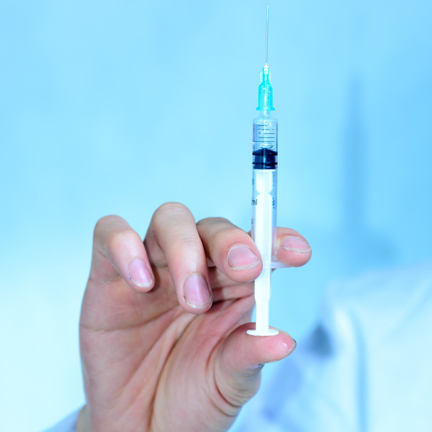 Doctor with medical syringe in hand - Foto, afbeelding