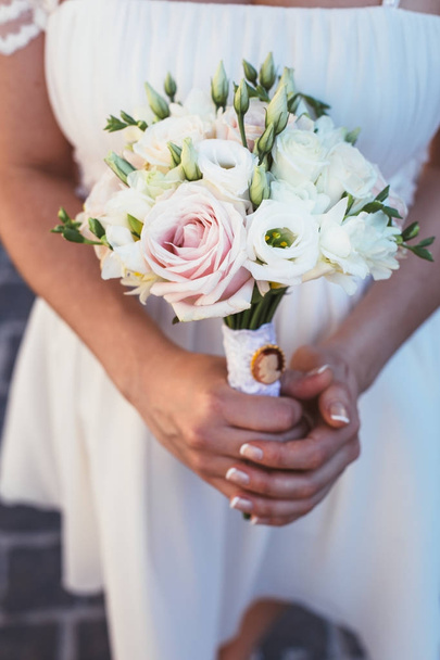 Beautiful wedding bouquet in hands of the bride - Fotó, kép
