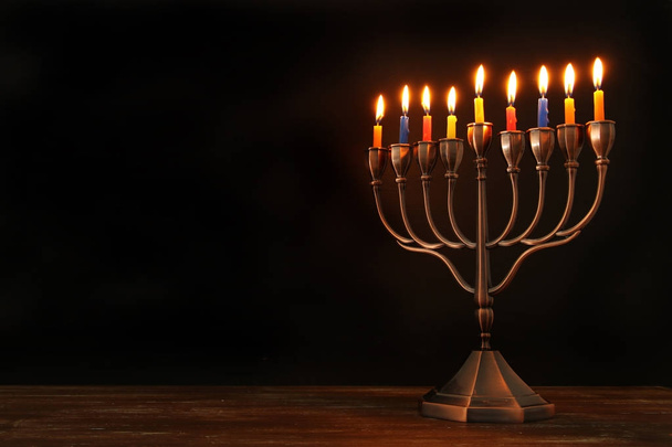 jewish holiday Hanukkah background with menorah (traditional candelabra) and burning candles - Foto, imagen